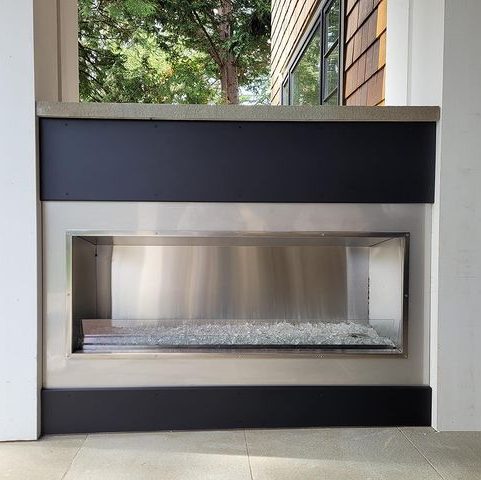 Modern fireplace with custom stainless steel and black metal panels.